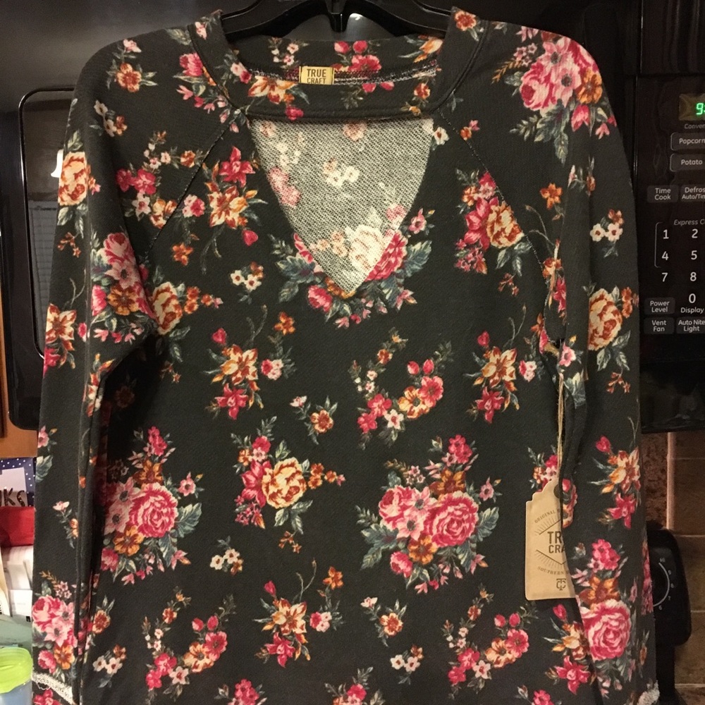 Floral top with eyelet below neck.